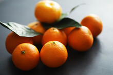 Citrus Fruits On A Gray Background. Tangerines With Leaves. Christmas Fruit.