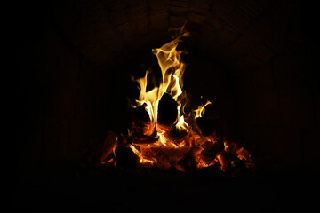 Wall Mural - Background of the flame in the oven. Tongues of fire in a brick fireplace. Fire texture.