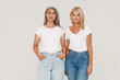 © Drobot Dean - Mature happy multiracial women wearing t-shirts posing at camera