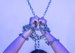 © Westend61 - Hands of woman tied with chain