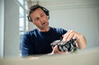 © Westend61 - Engineer examining lighting equipment talking on headset at office