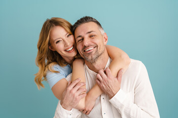 White happy couple hugging and looking at camera