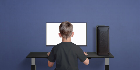 Leinwandbilder - Boy play game on desktop computer. Children in gaming. Isolated monitor display for video game promotion. Copy space beside