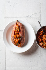 Wall Mural - Baked sweet potato stuffed with beans in tomato sauce.