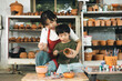 © Chanakon - Happy family moment Mother teaching son how to painting mug cup ceramic workshop. Child creative activities and art. Kid playing  pottery workshop. Developing children's learning skills.