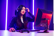 © Chanakon - Stressed Boring and loses. Young pretty asian woman playing game computer pc. Female Gamer on headphone playing video game  feeling sadness. Loss and Missed the chance to become a champion