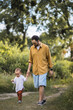 © Anastasia - A father spends time with his son. Happy parenthood. A father and his son are walking in the field. The father is his toddler son.