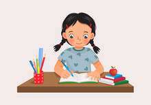 Cute Little Girl Sitting On The Desk Studying Writing On Notebook Doing Her Homework At Home