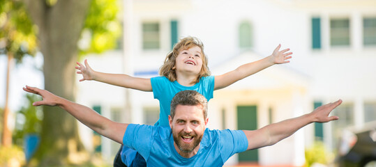 Wall Mural - Banner of father and son in summer park outdoor. parent relax with small child boy on grass. dad with kid on summer day. parenting