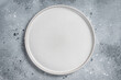 Empty white plate on table. Food cooking and healthy eating background. Gray background. Top view. Copy space