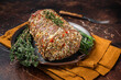 © Vladimir - Rolled meat pork roulade with rosemary and thyme. Dark background. Top view