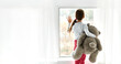 Loneliness. Lonely orphan girl in an orphanage looking outside while holding teddy bear the window. Child feelings concept