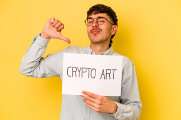 Wall Mural - Young hispanic man holding crypto art placard isolated on yellow background feels proud and self confident, example to follow.