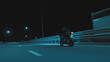 A man rides a sports motorcycle on a night track