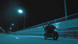 A man rides a sports motorcycle on a night track