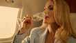 © stockbusters - Business partner talking jet closeup. Attractive woman rest drinking champagne