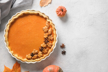 Thanksgiving Day American Pumpkin Pie decorated autumn leaves on white background. View from above. Flat lay. Copy space.