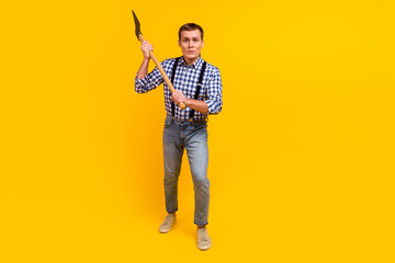 Destructive energy cutting wood danger concept lumberjack style man hold axe isolated on yellow color background