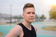 © Евгений Шемякин - portrait of handsome european slavic guy, young man standing outdoors looking at camera, training at gym outdoors