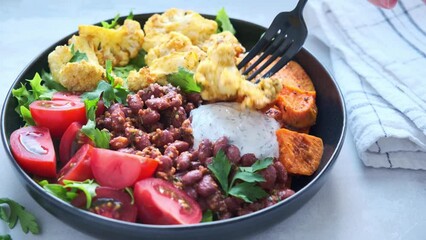 Wall Mural - Baked vegetables buddha bowl. Sweet potato, cauliflower, tomato and bean salad. Vegan recipe.