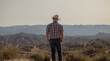 © WeeKwong - Rear view of adult man in sun hat and shirt in desert. Almeria, Spain