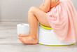 Child on the potty with stomach pain. Toilet problems.