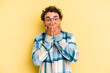 © Asier - Young caucasian man isolated on yellow background shocked covering mouth with hands.