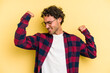 © Asier - Young caucasian man isolated on yellow background celebrating a special day, jumps and raise arms with energy.