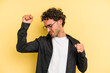 © Asier - Young caucasian man isolated on yellow background celebrating a special day, jumps and raise arms with energy.