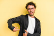 © Asier - Young caucasian man isolated on yellow background having a liver pain, stomach ache.
