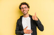 © Asier - Young caucasian man isolated on yellow background touches tummy, smiles gently, eating and satisfaction concept.