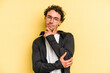 © Asier - Young caucasian man isolated on yellow background thinking and looking up, being reflective, contemplating, having a fantasy.