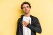 © Asier - Young caucasian man isolated on yellow background taking an oath, putting hand on chest.