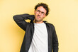 © Asier - Young caucasian man isolated on yellow background massaging elbow, suffering after a bad movement.