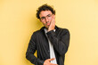 © Asier - Young caucasian man isolated on yellow background blows cheeks, has tired expression. Facial expression concept.