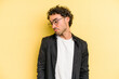 © Asier - Young caucasian man isolated on yellow background shrugs shoulders and open eyes confused.