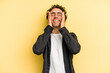 © Asier - Young caucasian man isolated on yellow background laughs joyfully keeping hands on head. Happiness concept.