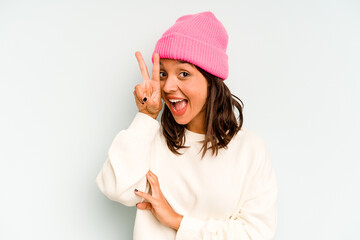 Wall Mural - Young hispanic woman isolated on blue background shocked and amazed holding a copy space between hands.