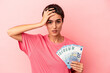 © Asier - Young caucasian woman holding banknotes isolated on pink background being shocked, she has remembered important meeting.