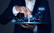 © Miha Creative - Businessman draws increase arrow graph corporate future growth year 2022 to 2023. Planning,opportunity, challenge and business strategy. New Goals, Plans and Visions for Next Year 2023.