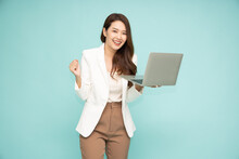 Happy Asian Businesswoman Holding Laptop Computer Isolated On Green Background And Looking At Camera