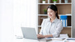 © PaeGAG - Asian woman working with laptop in her office. business financial concept.