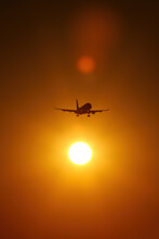 Airplane Silhouette In Sunset Orange Sky.