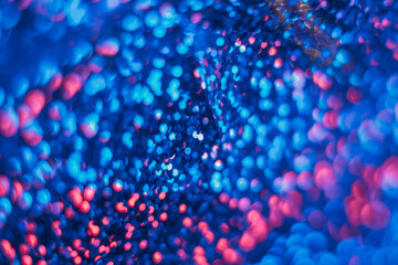 Wall Mural - Neon bokeh glow. Fluorescent abstract background. Cyber illumination. Defocused navy blue pink color circles light flare futuristic texture.