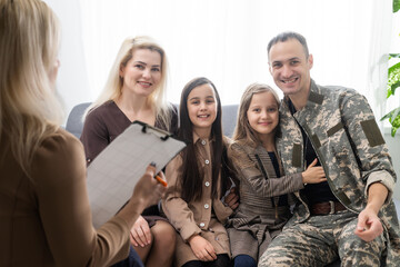 Psychologist making notes during therapy session with soldier, PTSD