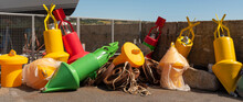 Penzance Harbour, Cornwall, England, UK. 2022. Colourfull Selection Of Plastic Buoys For Mooring Navigation And Navigation On The Harbour Wall. Penzance, Cornwall, UK