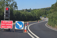 Cars Approach From The Opposite Direction At Roadworks Controlled By Traffic Lights