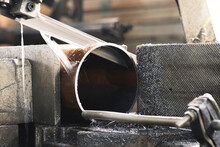 Cutting A Large Pipe With A Band Saw, At The Factory. Close-up.	

