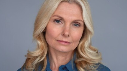 Wall Mural - Confident adult age 50 years old female manager portrait looking at camera. Closeup headshot of sophisticated business woman, portrait.