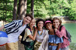 © Halfpoint - Group of young friends on camping trip near lake in summer.